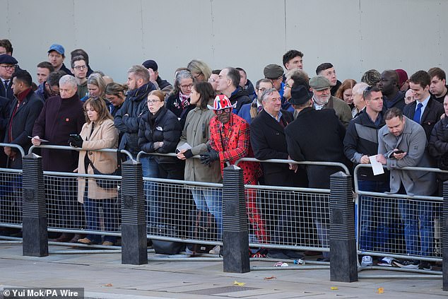 Royal fan Joseph Afrane wears patriotic clothing decked with poppies on Whitehall