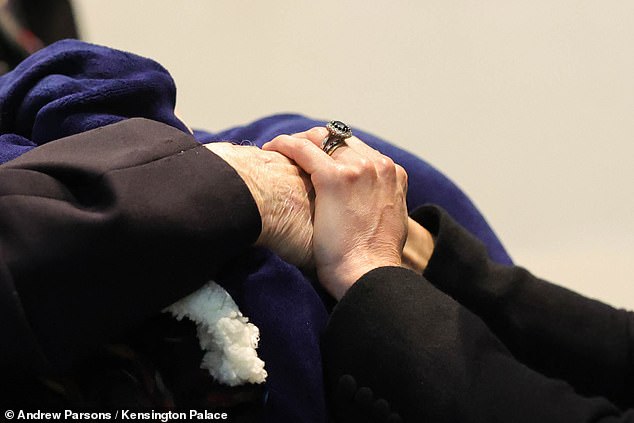 Kate holds hands with a veteran during her visit to the National Memorial Arboretum today