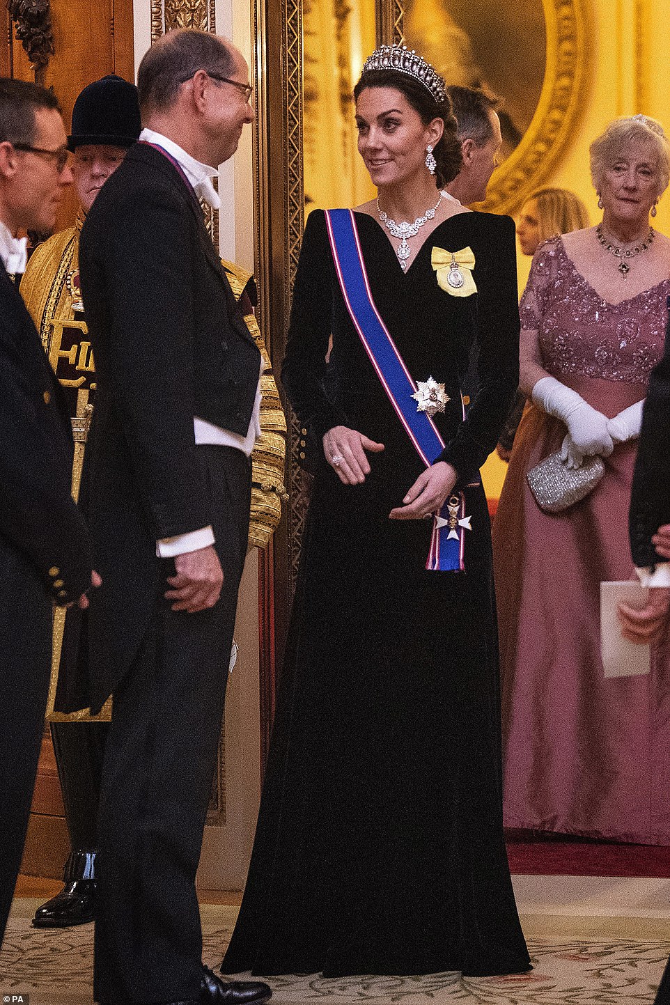 The Duchess of Cambridge at the evening reception in her lavish floor length gown looked delighted to speak to guests