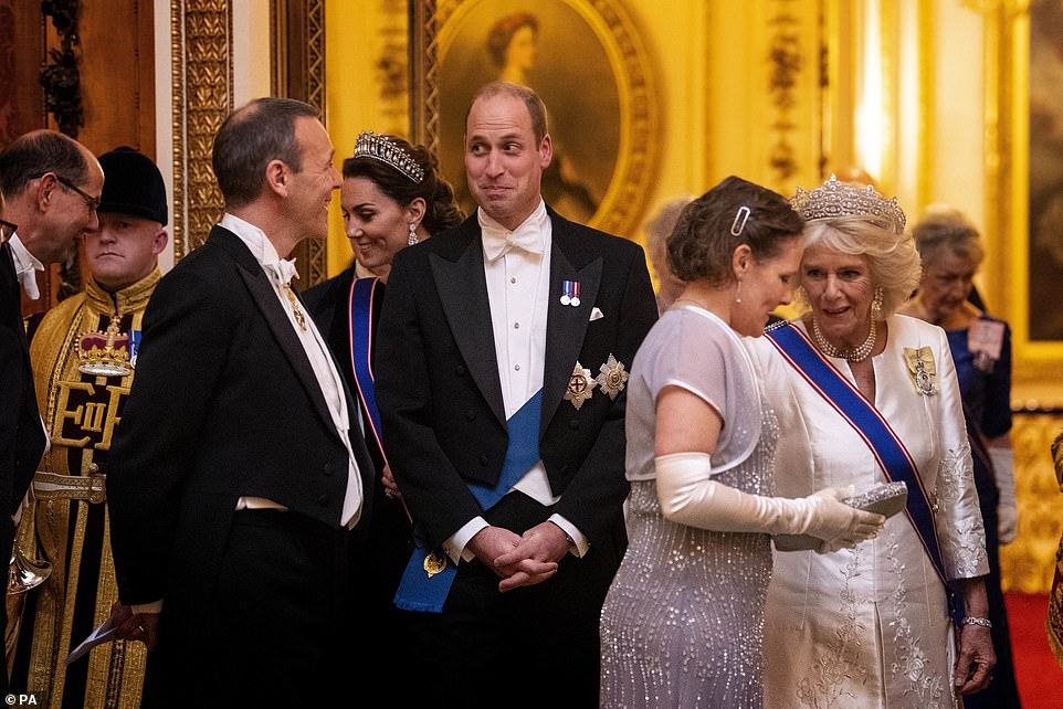 Prince William appeared to share a joke with one guest while they chatted during the reception at Buckingham Palace this evening