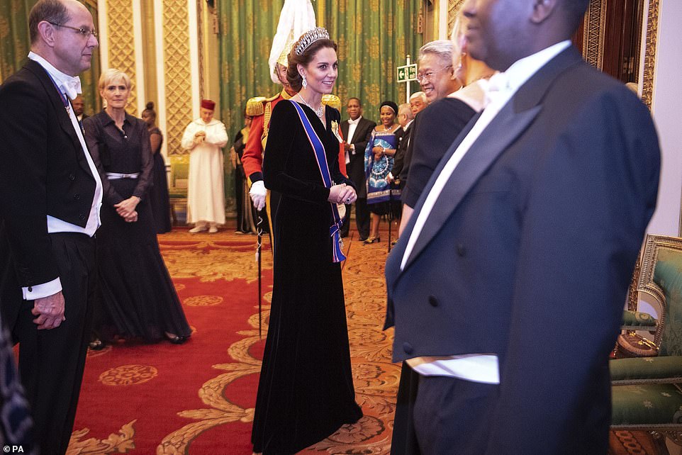 The Duchess of Cambridge opted for a dark navy velvet Alexander McQueen gown for the occasion at Buckingham Palace this evening