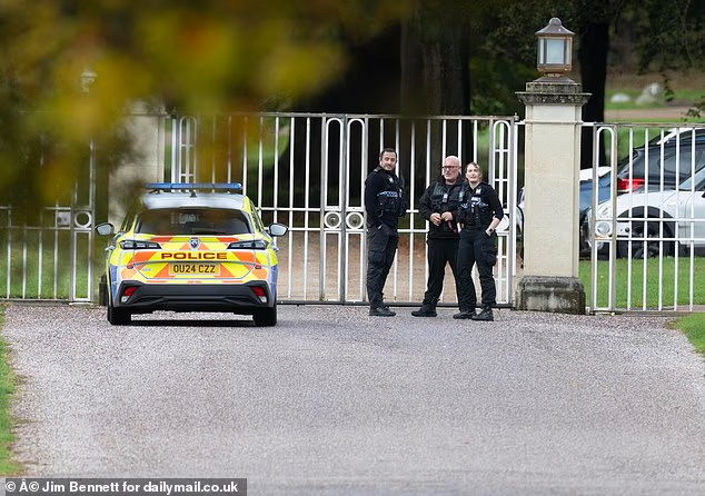 Police guard the gates of Andrew and Fergie's home today