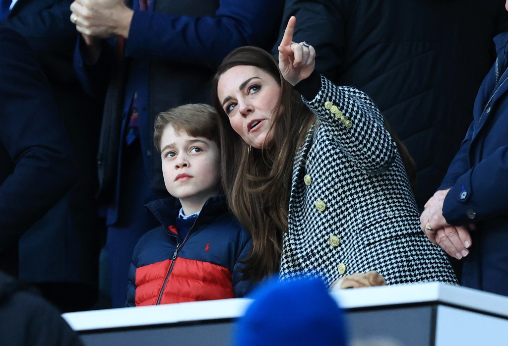 Catherine, Duchess of Cambridge speaks to her son Prince George before a rugby match.