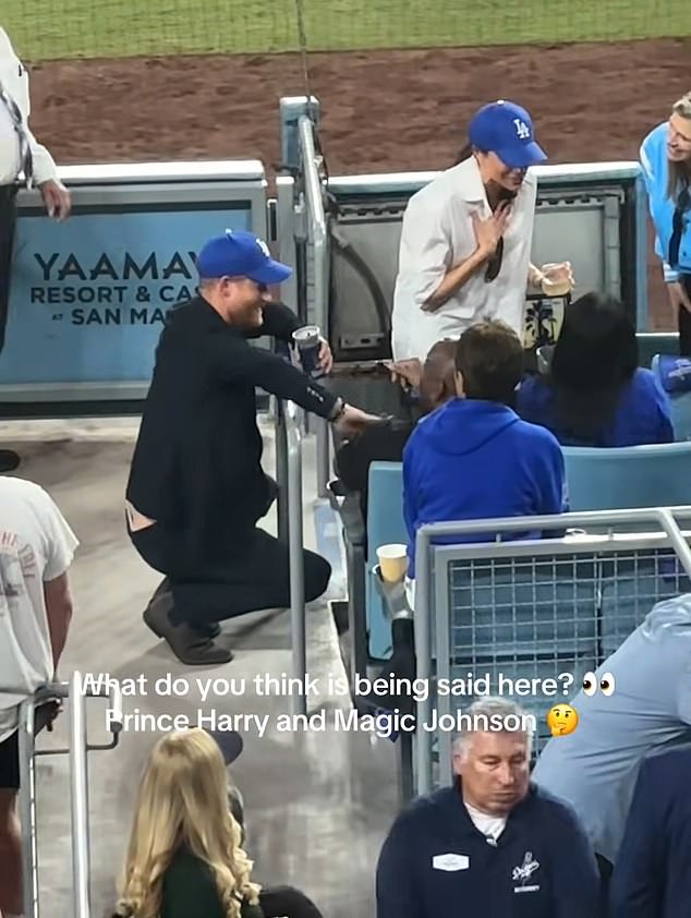 Footage shows Harry and Meghan chatting up a storm with basketball icon and part-owner of the team Magic Johnson, who was relegated to the second row