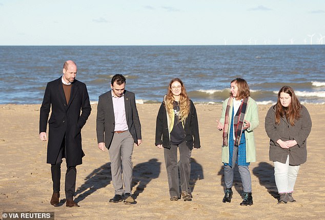 Despite chilly weather, William braved a walk along the beach despite the sea breeze