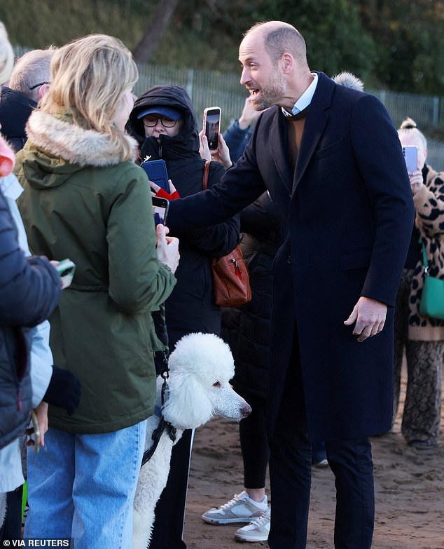Wearing a navy coat and brown jumper, he appeared in good spirits for a walkabout