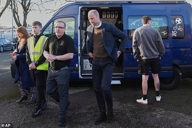 William speaks to Scott Jenkinson, left, as he visits YouthShedz in Mochdre, Colwyn Bay