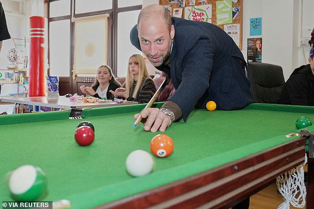 Prince William plays pool during a visit to a Youth Shedz centre in Mochdre, near Colwyn Bay, Wales