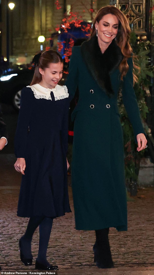 Charlotte, dressed in a navy dress, stayed close to her mother as they entered the event on Friday evening