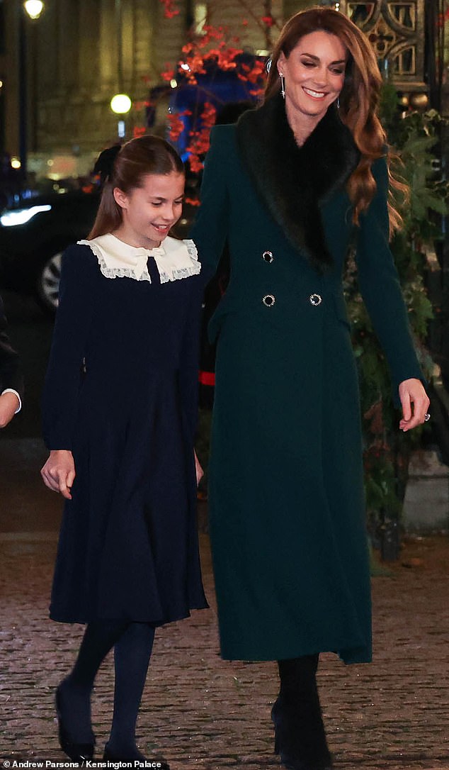 Charlotte, who wore a navy dress, stayed close to her mother as they entered the event