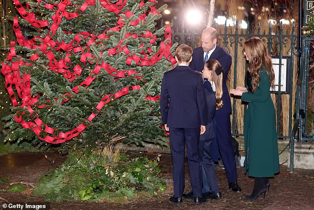 The Wales' all appeared to add their names to the Christmas tree paper chain ahead of the service