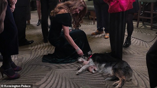 Kate paired her delightfully festive emerald green dress with matching Manolo Blahnik pumps, but the high heels didn't stop the mother-of-three from gracefully bending to greet the furriest guest of the evening