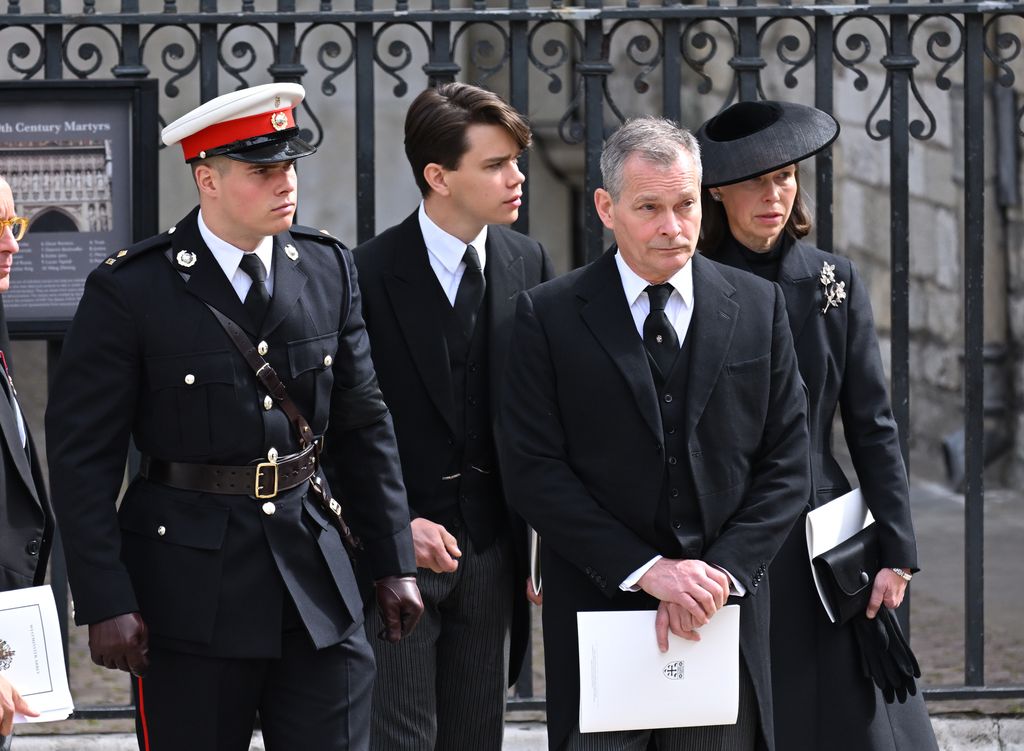 Image may contain Alexander Rybak Eva GlawischnigPiesczek Clothing Hat Accessories Formal Wear Tie Adult and Person