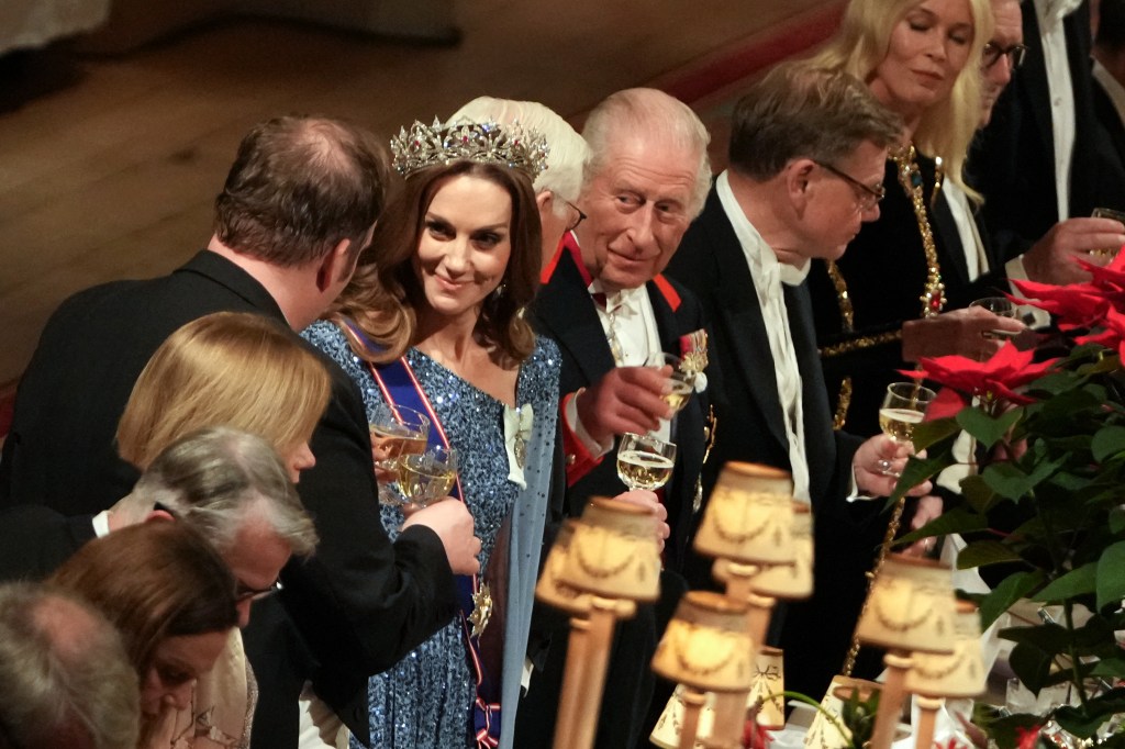 King Charles III, Germany's President Frank-Walter Steinmeier and Britain's Catherine, Princess of Wales toast their glasses after the King delivered a speech.