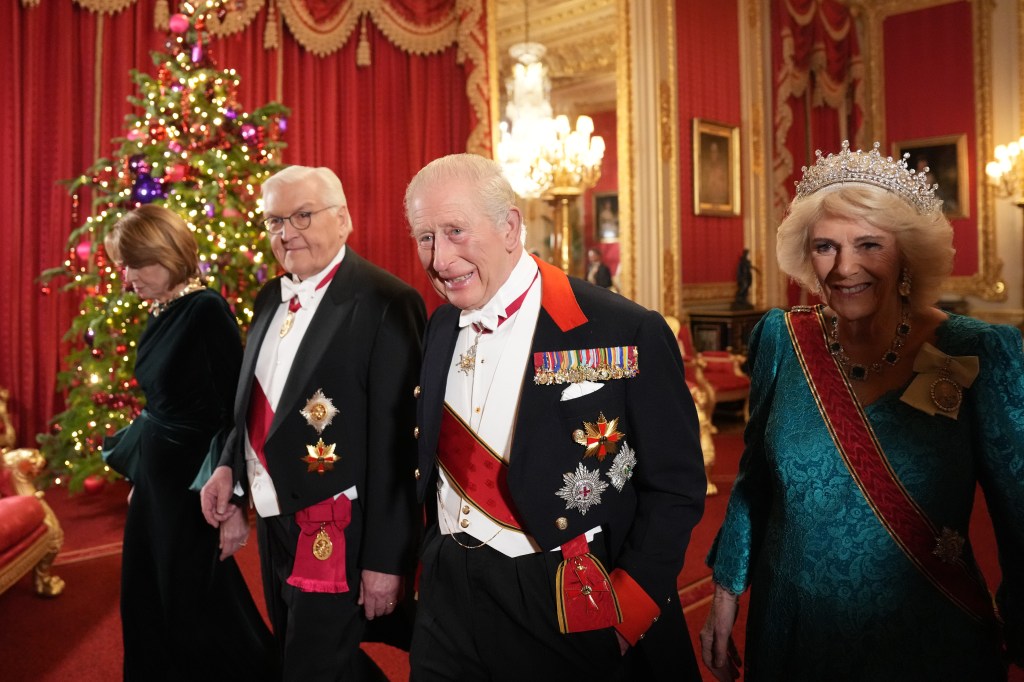 King Charles III, Queen Camilla, German President Frank-Walter Steinmeier, and Elke Büdenbender in formal attire at Windsor Castle.
