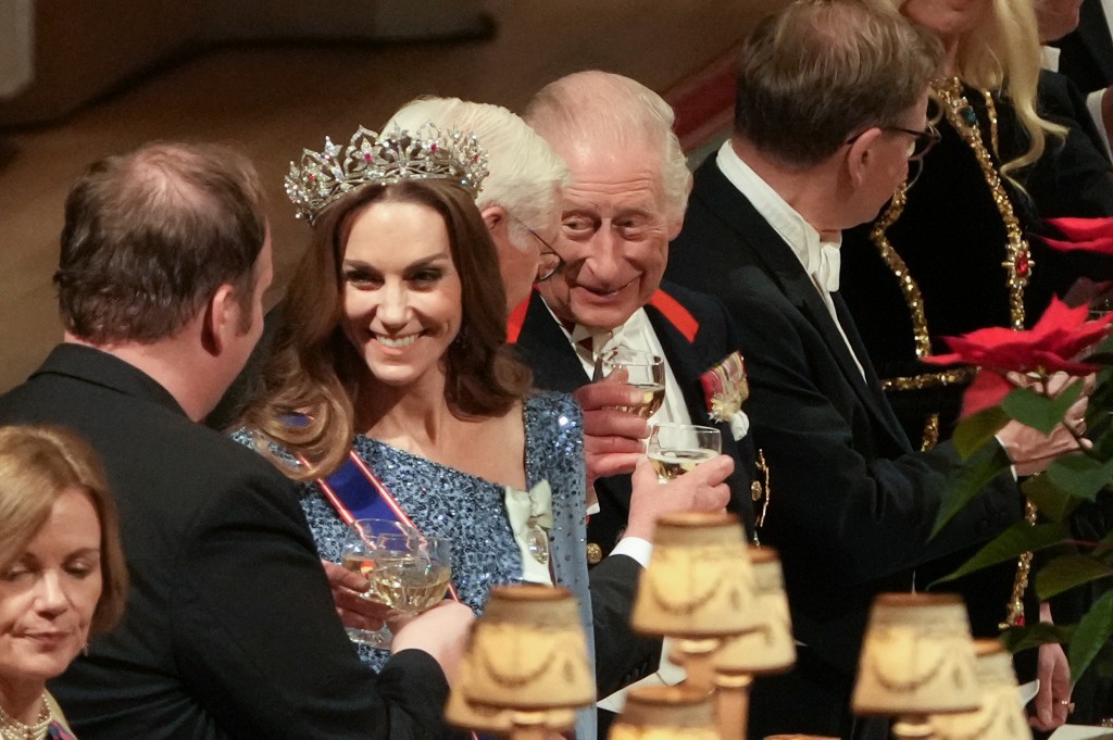 Catherine, Princess of Wales, King Charles III, and Germany's President Frank-Walter Steinmeier toast their glasses at a state banquet.