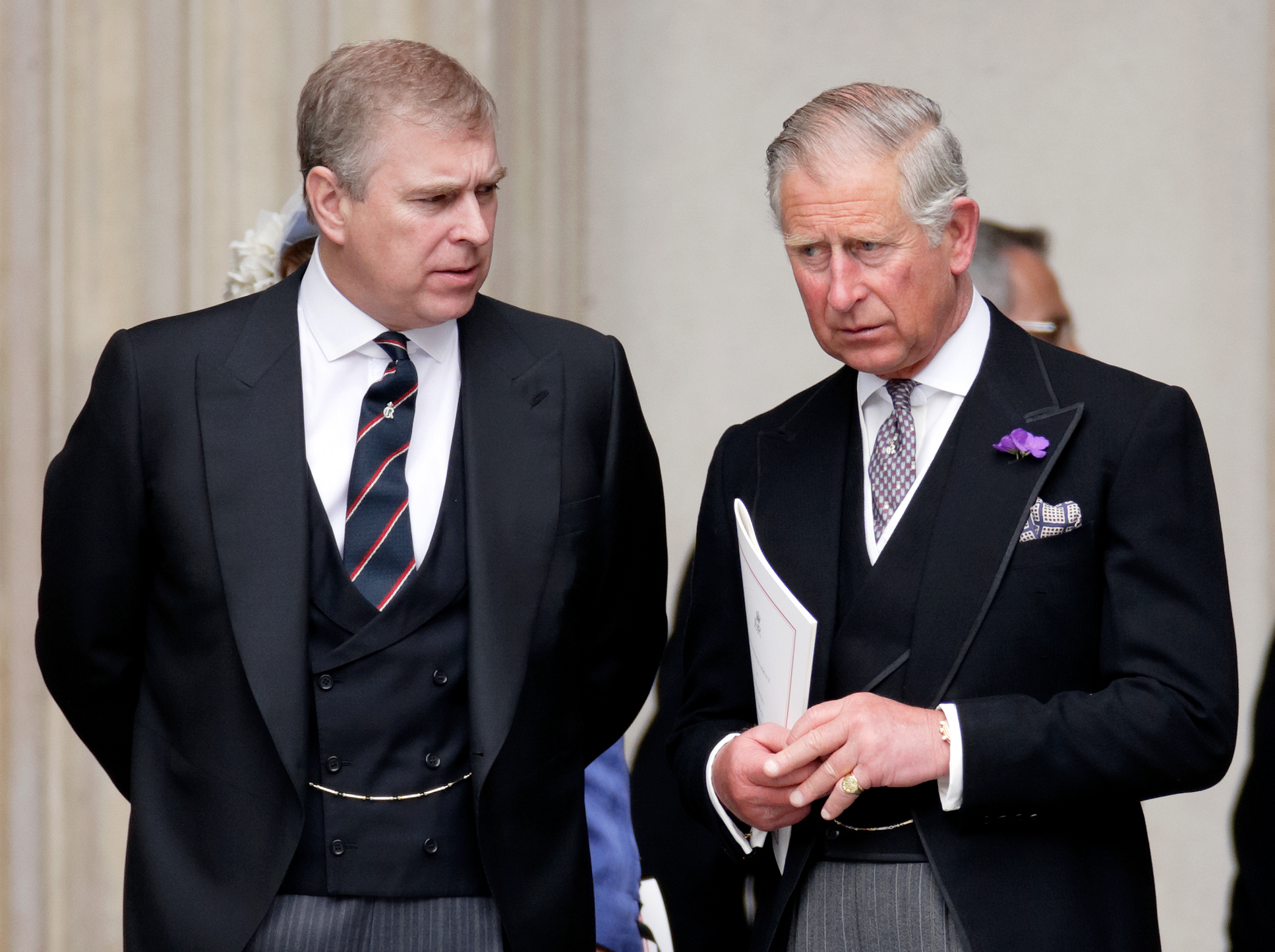 Prince Andrew and King Charles wearing black suits
