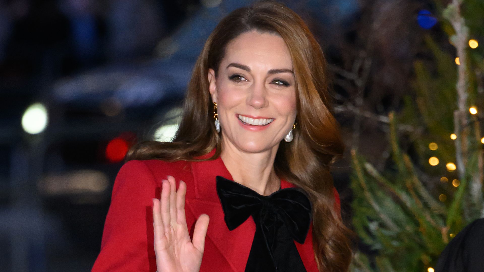 Kate Middleton in red coat by Christmas tree