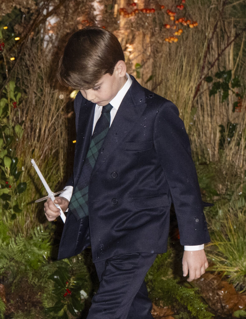 Prince Louis in suit holding a candle at Christmas carol service