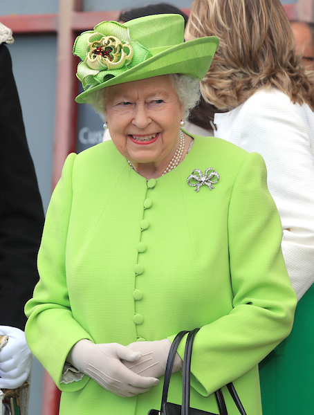 Queen Elizabeth II smiling in green suit