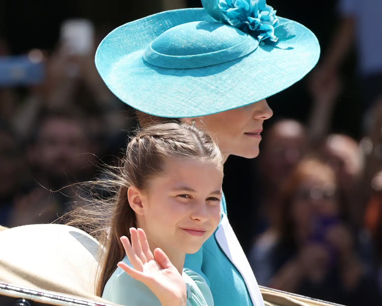 Princess Charlotte and Kate Middleton riding in a horse and carriage