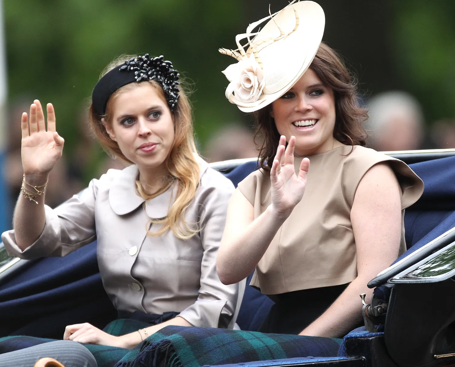 Princess Beatrice and Princess Eugenie waving to onlookers