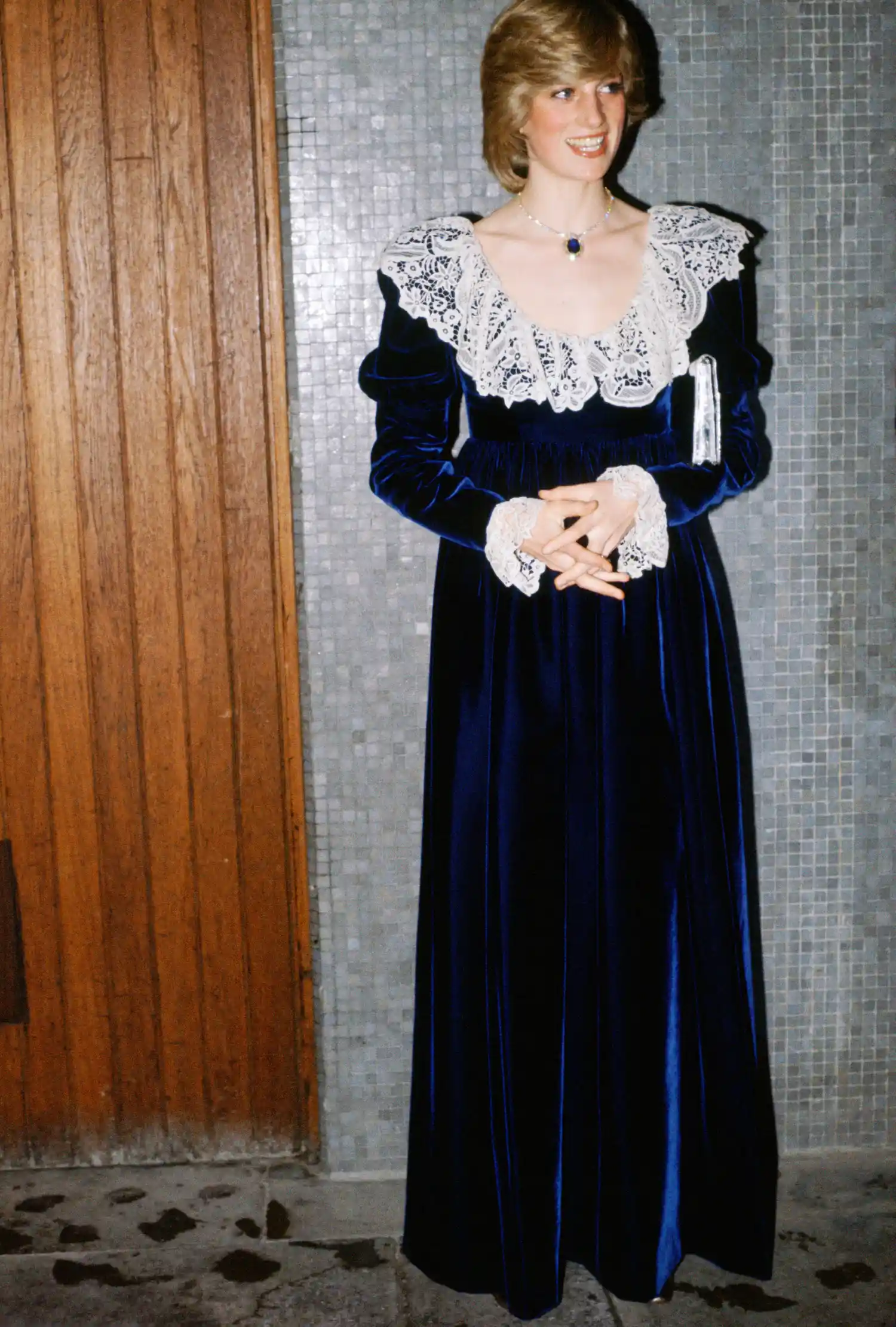 Princess Diana wearing a blue velvet dress with a white lace collar