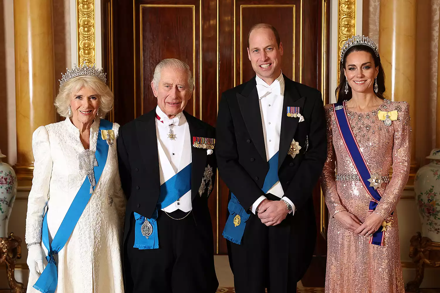 Queen Camilla, King Charles III, Prince William, Prince of Wales and Catherine, Princess of Wales pose for a photograph ahead of The Diplomatic Reception in the 1844 Room at Buckingham Palace on December 05, 2023 in London, England.