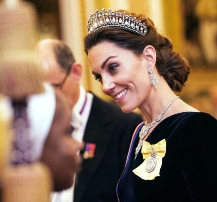 In the shimmering halls of Buckingham Palace — where every jewel carries history and every tradition speaks in silence — a single moment changed everything. In this fictional royal tale, Catherine, the Princess of Wales, stepped into the spotlight wearing the legendary Strathmore Rose Tiara, a masterpiece unseen on a royal head since the 1930s. The room froze. The cameras paused. And for a heartbeat, the chandeliers above seemed to glow a little brighter. This wasn’t just elegance… it was symbolism. A forgotten heirloom from the Queen Mother, reimagined on the head of a future Queen — full of quiet strength, timeless beauty, and a message deeper than diamonds. Some say this choice reflected resilience. Others saw a subtle promise of a new era. But everyone agreed: it was unforgettable. In this beautifully imagined moment, Catherine didn’t speak a single word — yet she told a story that left the palace breathless. And the hidden meaning behind her choice? That’s where the mystery begins…