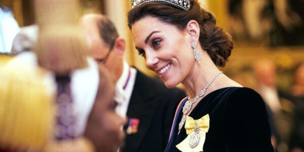 In the shimmering halls of Buckingham Palace — where every jewel carries history and every tradition speaks in silence — a single moment changed everything. In this fictional royal tale, Catherine, the Princess of Wales, stepped into the spotlight wearing the legendary Strathmore Rose Tiara, a masterpiece unseen on a royal head since the 1930s. The room froze. The cameras paused. And for a heartbeat, the chandeliers above seemed to glow a little brighter. This wasn’t just elegance… it was symbolism. A forgotten heirloom from the Queen Mother, reimagined on the head of a future Queen — full of quiet strength, timeless beauty, and a message deeper than diamonds. Some say this choice reflected resilience. Others saw a subtle promise of a new era. But everyone agreed: it was unforgettable. In this beautifully imagined moment, Catherine didn’t speak a single word — yet she told a story that left the palace breathless. And the hidden meaning behind her choice? That’s where the mystery begins…