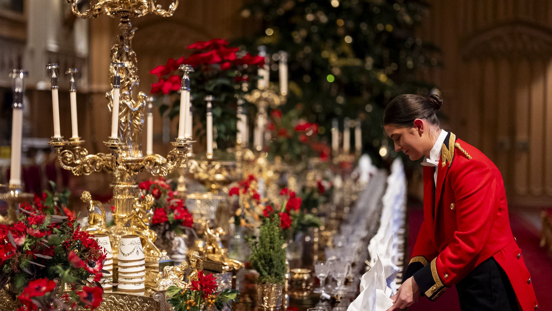 A staff member preparing a table