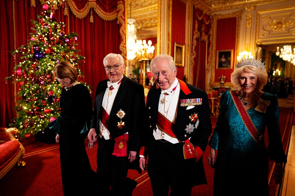 Queen Camilla, King Charles III, Elke Budenbender, and German President Frank-Walter Steinmeier walking in Windsor Castle.
