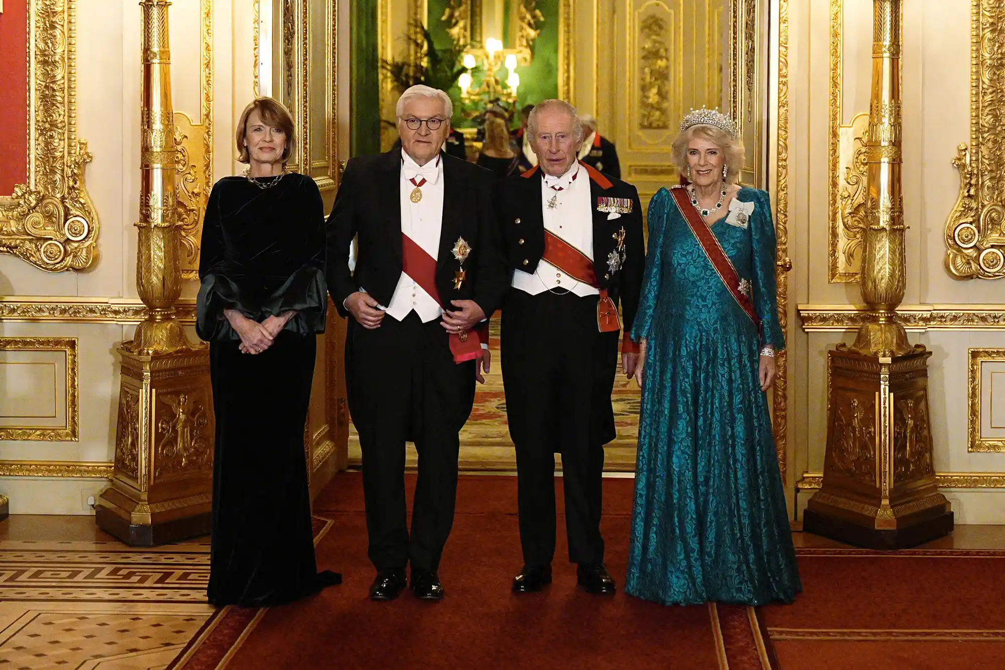 Britain's King Charles III (2R) and his wife Britain's Queen Camilla (R) pose with Germany's President Frank-Walter Steinmeier (2L) and his wife Elke Buedenbender as they arrive to attend a State Banquet at Windsor Castle in Windsor, on December 3, 2025, the first day of a three day state visit by the German President. President Frank-Walter Steinmeier received a ceremonial welcome to Britain Wednesday as his state visit got into full swing -- the first by Germany's official head of state in 27 years.