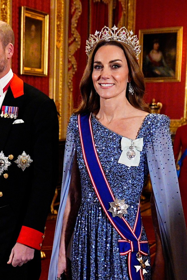 The Princess of Wales wearing a sparkling blue dress, tiara, sash, and medals at a state banquet.