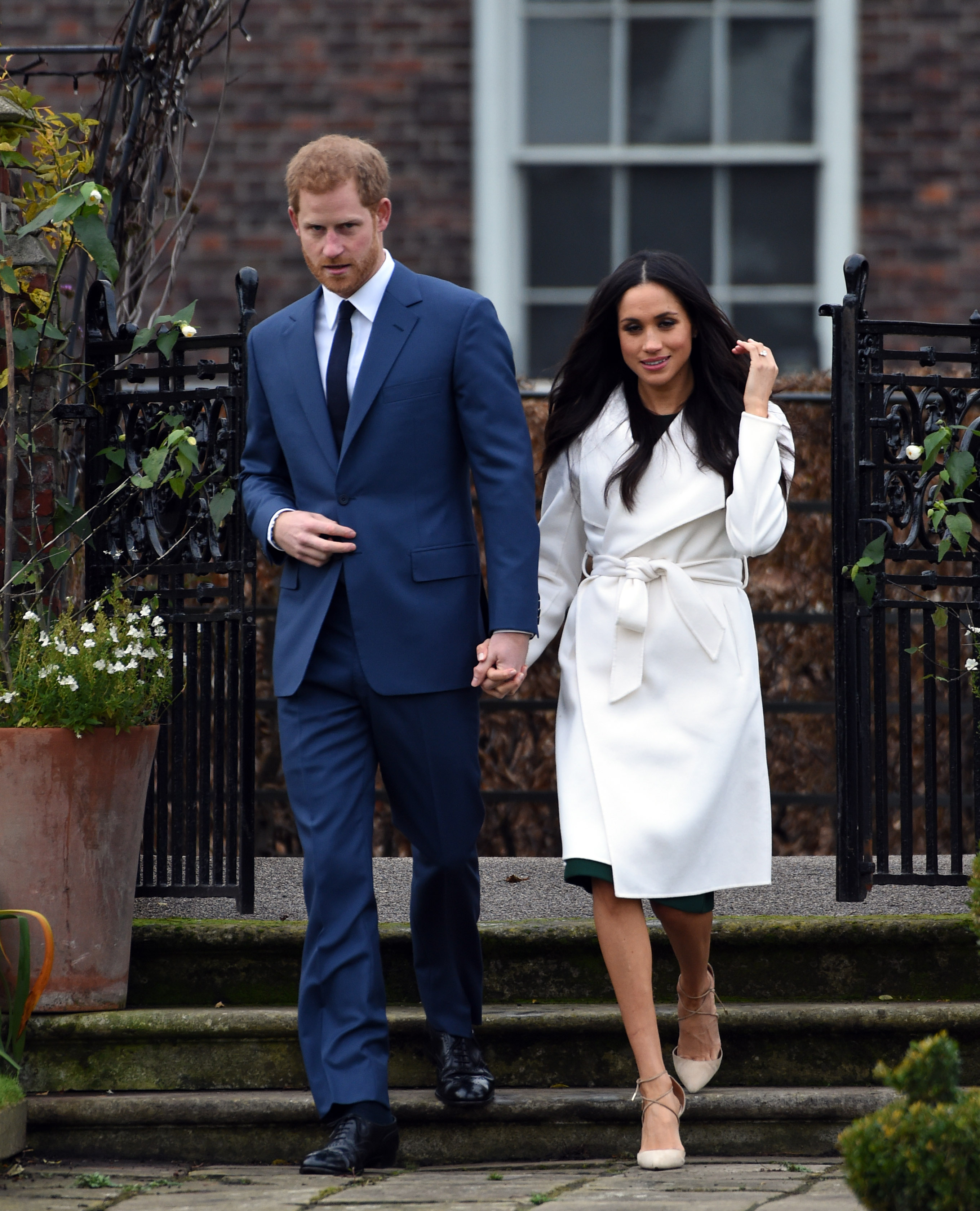 Prince Harry and Meghan Markle holding hands at their engagement photocall.