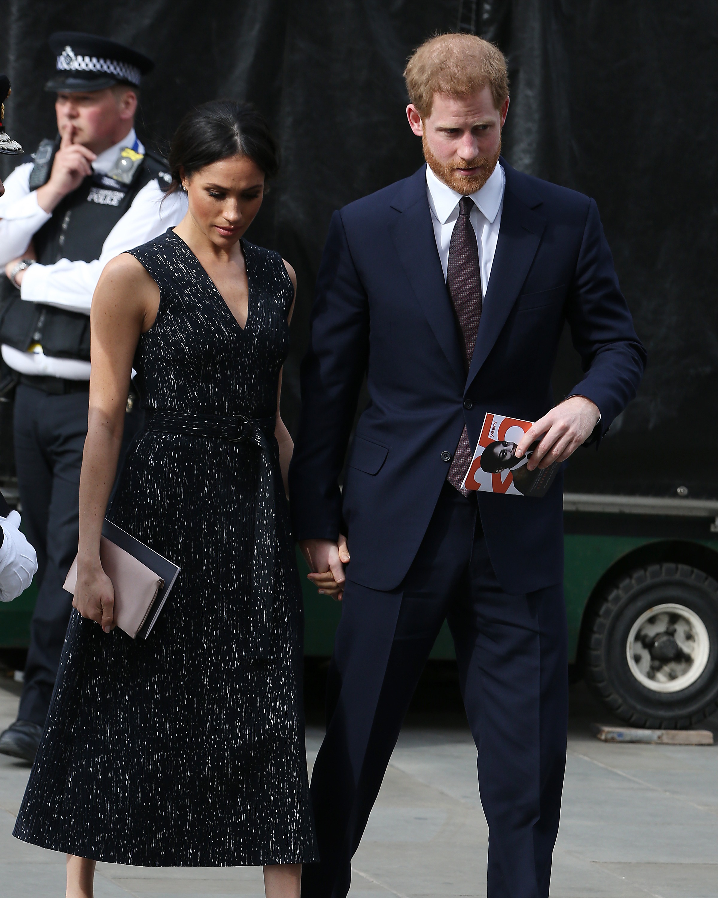 Meghan Markle and Prince Harry holding hands.