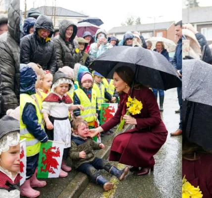 Princess Catherine comforts a child in the rain.