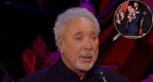 Last night, under the grand arches of Royal Albert Hall, the air was thick with reverence. A single spotlight fell on Sir Tom Jones, 84, as he stood before a hushed audience — his voice trembling but timeless. Backed by a military orchestra, he began to sing “I Won’t Crumble With You If You Fall,” his every note carrying the weight of a lifetime.