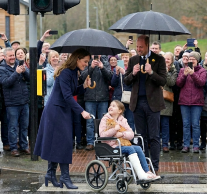 Watch the heart-stopping moment Catherine abandons her umbrella to transform into a human shield in the pouring rain!