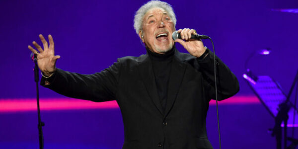 The arena went still — no coughs, no shuffling, no chatter — as Tom Jones repeated the line, his voice carrying decades of love, loss, and lessons learned. This wasn’t just a performance. It was a confession. First released in the late 1960s, I’ll Never Fall In Love Again was already a classic, but in Tom’s hands that night, it became something more — a living, breathing story. Each note trembled with vulnerability yet burned with the strength of someone who’s survived heartbreak and lived to tell it. The lush arrangement wrapped around him like a memory, the melody pulling the crowd through every high and low of love’s dangerous game. Some in the audience wiped away tears. Others simply sat frozen, afraid to break the spell. For those few minutes, it didn’t matter if you’d been in love, lost love, or just dreamed of it — you felt it. And when the final note faded, it left behind a silence that spoke louder than applause. Because some songs don’t just get sung… they get lived.