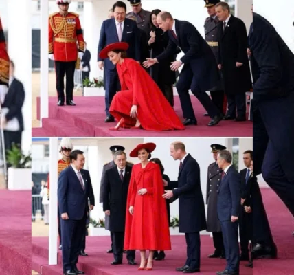 As Catherine was walking onto the stage in her striking bright red outfit As Catherine was walking onto the stage in her striking bright red outfit